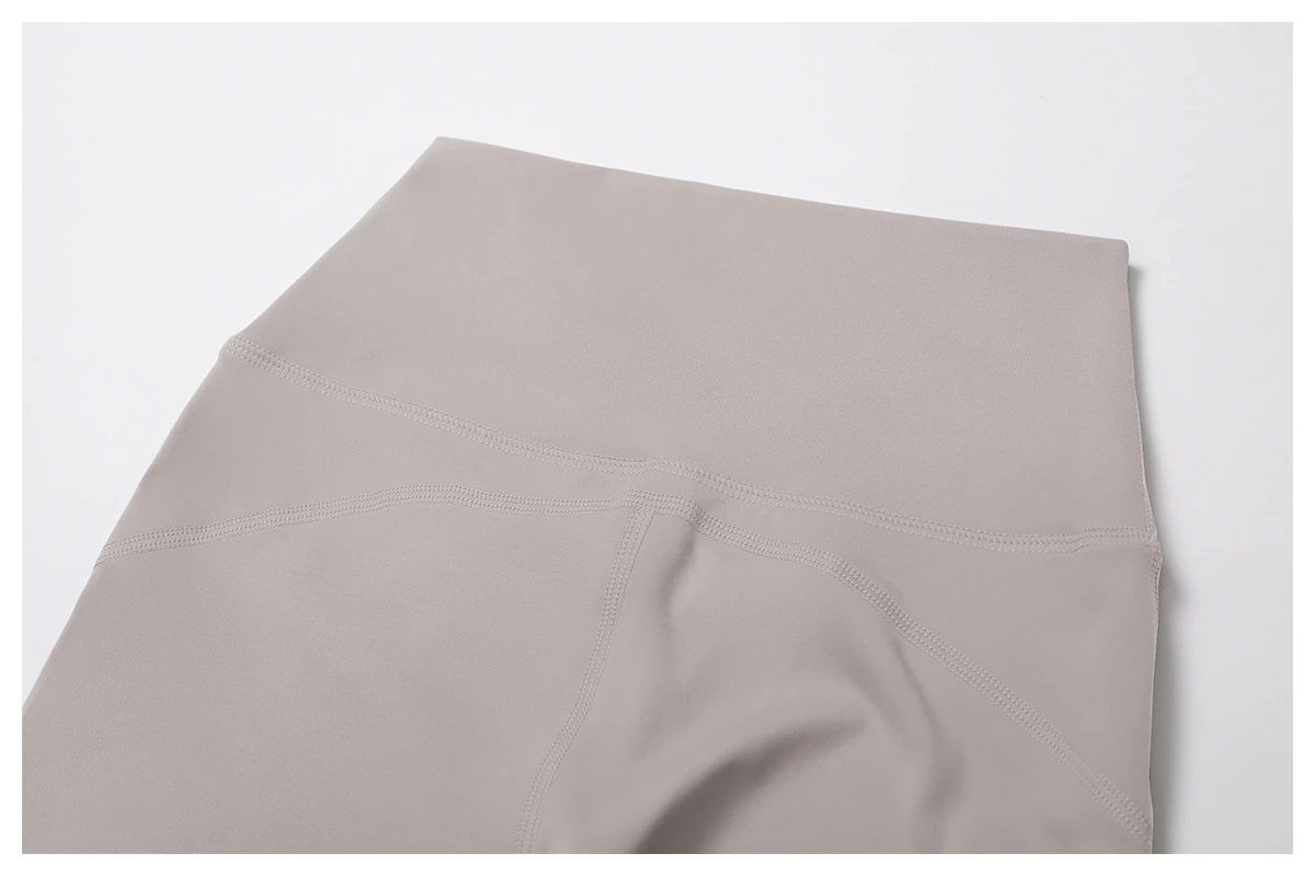 Neutral gray-beige waistband with curved panel seams and visible stitching.
