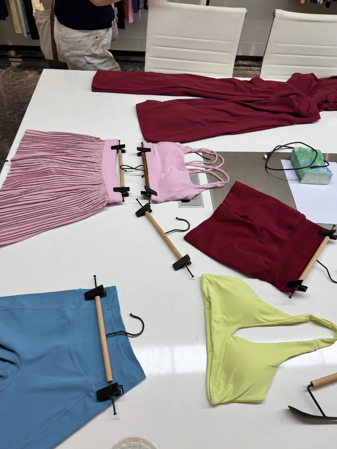 Activewear samples laid out on a showroom table for discussion.
