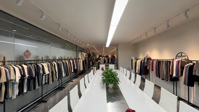 Meeting table surrounded by apparel samples in the showroom.