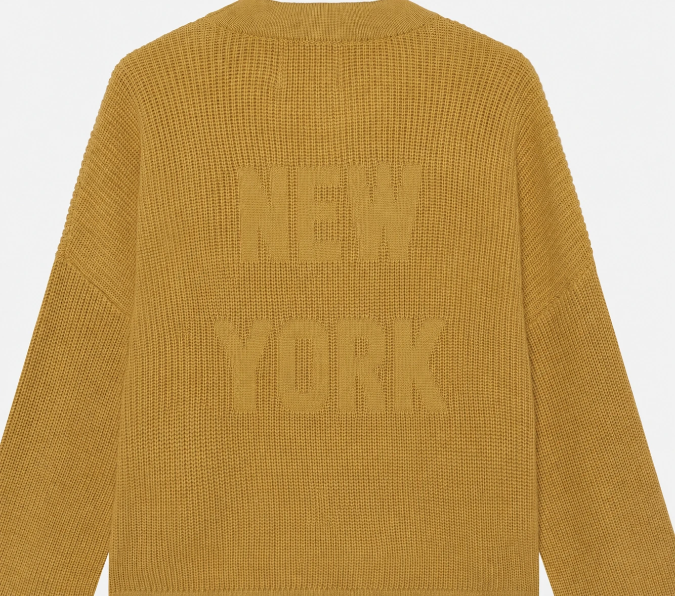 Customer-supplied mustard knit reference with anonymized relief lettering.