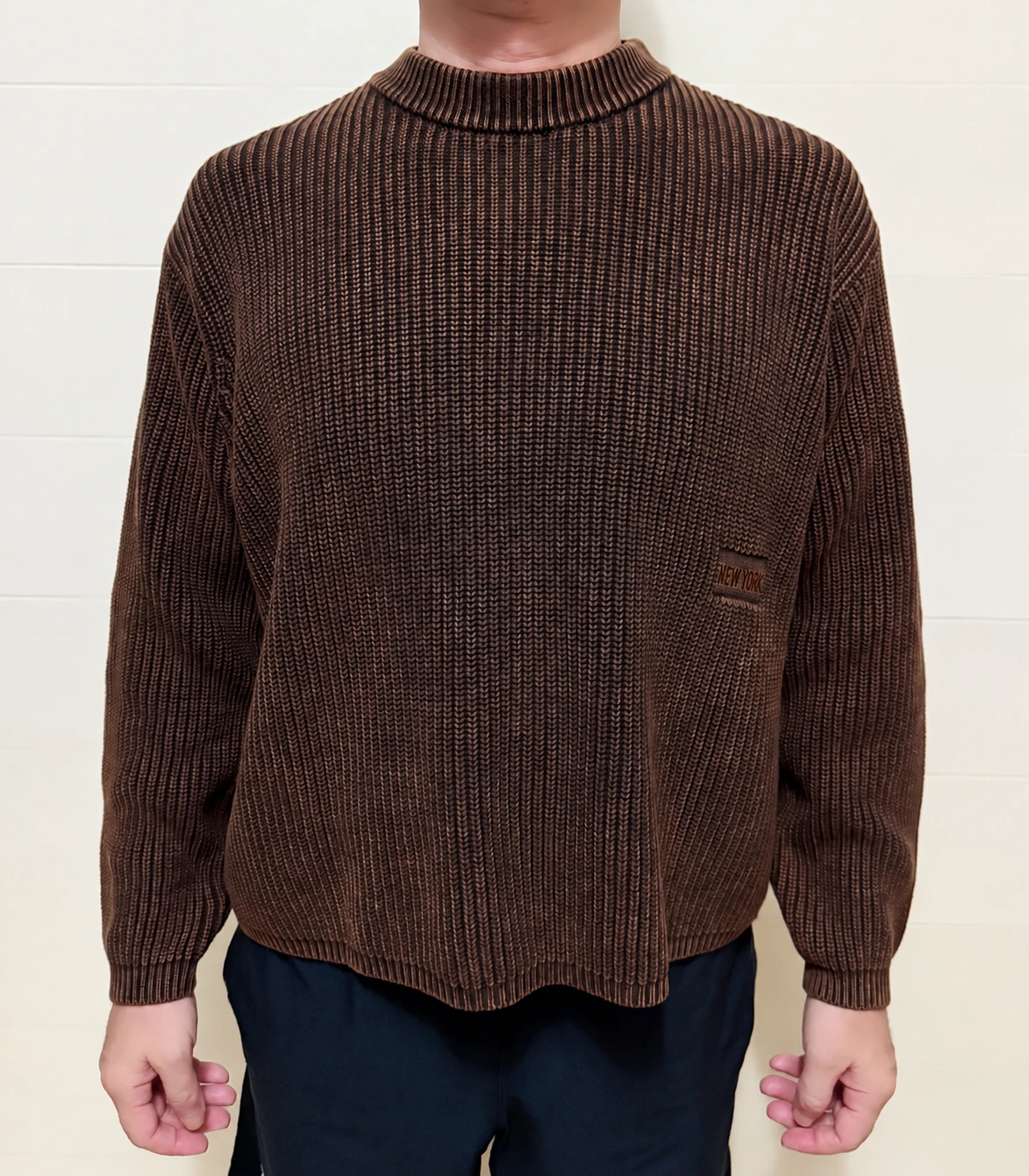 Developed brown cotton sweater sample, front view with a small anonymized embroidered detail.